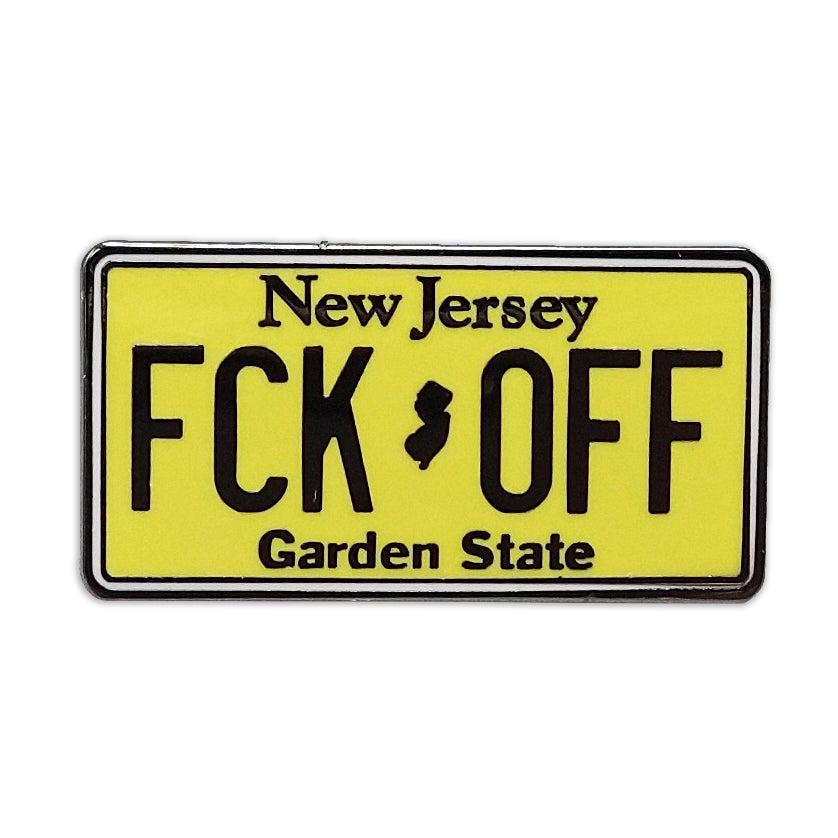 An enamel pin shaped like a New Jersey license plate with the text 'FCK OFF' on it.